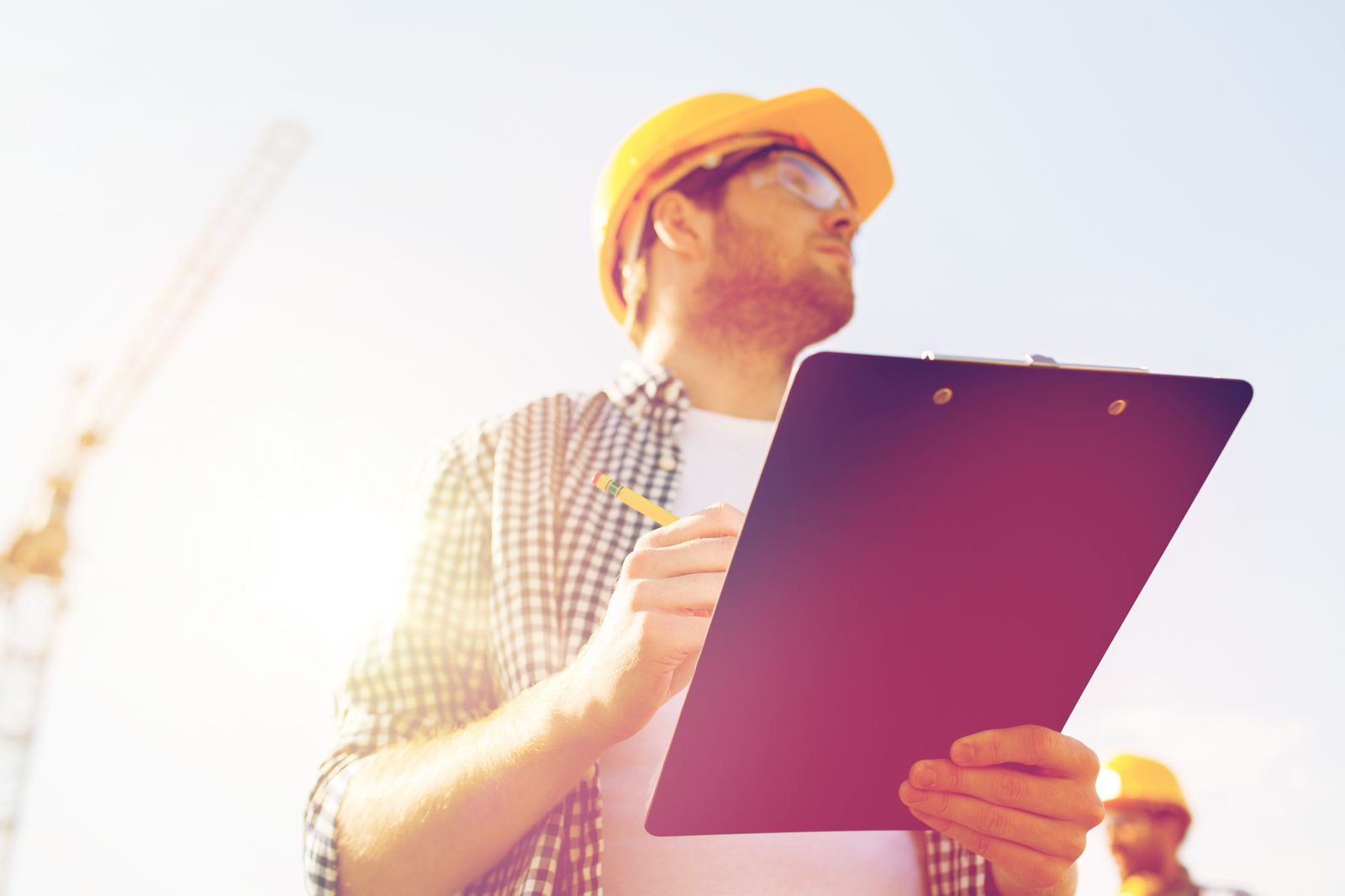 Portrait of a man in a hard hat holding a clipboard, standing in for the owner's photo